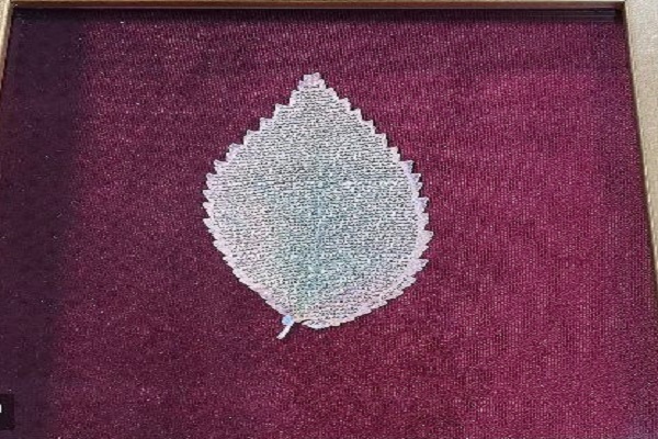 کتابت قرآن روی برگ